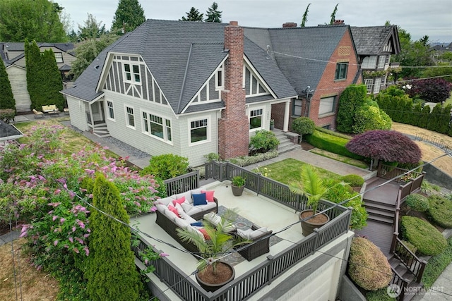 2663 37th Ave SW, Seattle, WA 98126 - rear view of house featuring an outdoor living space, a shingled roof, and a chimney