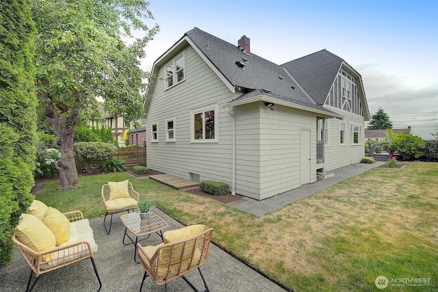 2663 37th Ave SW, Seattle, WA 98126 - back of house featuring a shingled roof, a chimney, a patio, and a yard