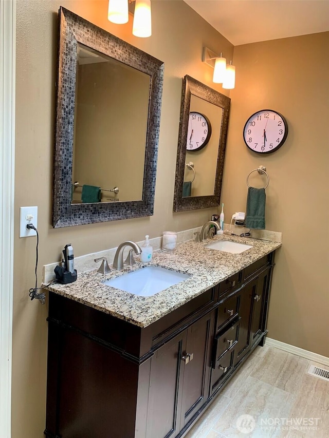 6214 145th St SE, Everett, WA 98208 - bathroom featuring double vanity and baseboards