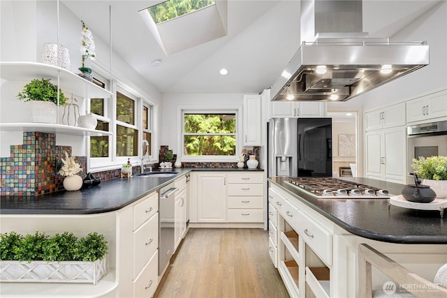 5265 140th Ave NE, Bellevue, WA 98005 - kitchen featuring wall chimney range hood, stainless steel appliances, dark countertops, light wood finished floors, and white cabinets