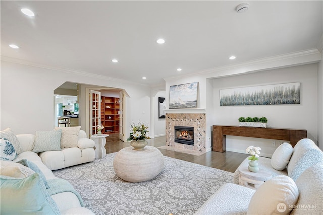 5265 140th Ave NE, Bellevue, WA 98005 - living room with crown molding, wood finished floors, a tile fireplace, recessed lighting, and arched walkways