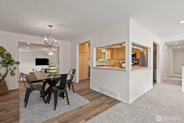 11404 SE 186th St, Renton, WA 98055 - dining room featuring a chandelier, recessed lighting, and wood finished floors