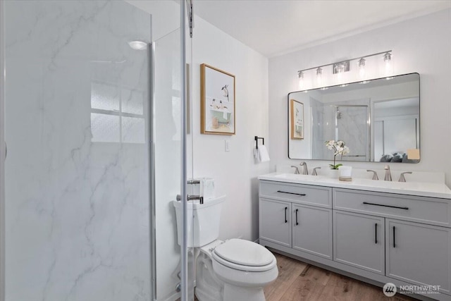 11404 SE 186th St, Renton, WA 98055 - bathroom featuring a marble finish shower, double vanity, and wood finished floors