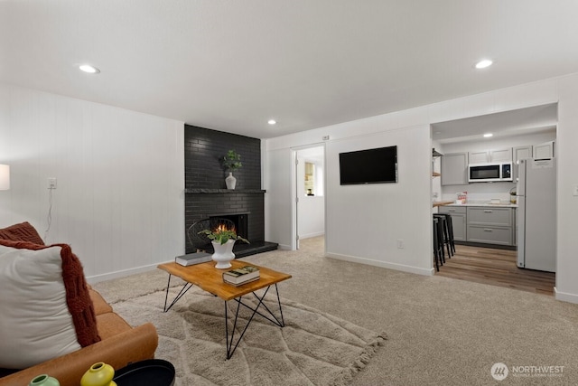 11404 SE 186th St, Renton, WA 98055 - living room with light colored carpet, a brick fireplace, and recessed lighting