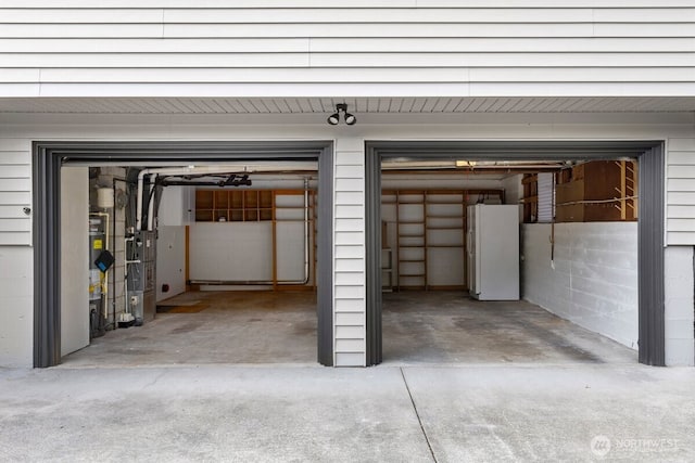 11404 SE 186th St, Renton, WA 98055 - garage featuring freestanding refrigerator and concrete driveway
