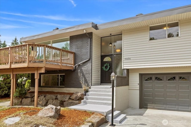 11404 SE 186th St, Renton, WA 98055 - doorway to property featuring a garage, brick siding, concrete driveway, and a deck