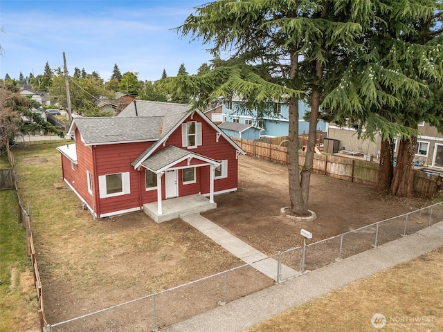 910 E 60th St, Tacoma, WA 98404 - bungalow-style home featuring roof with shingles and a fenced backyard