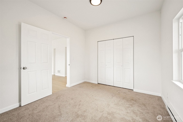 910 E 60th St, Tacoma, WA 98404 - unfurnished bedroom featuring carpet, baseboard heating, and a closet