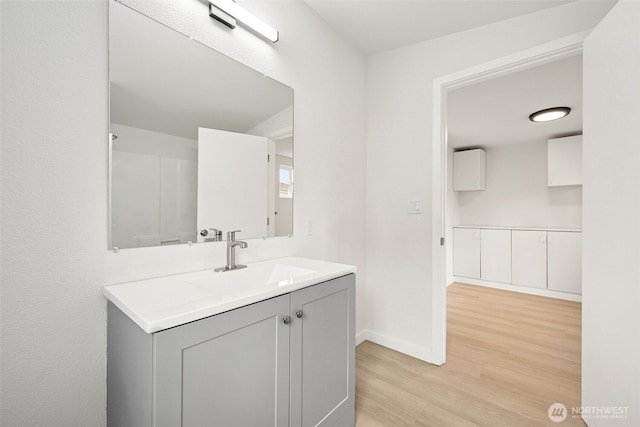 910 E 60th St, Tacoma, WA 98404 - bathroom with wood finished floors and vanity