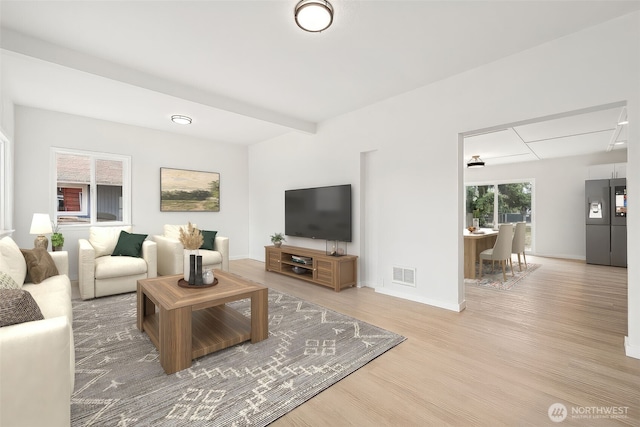 910 E 60th St, Tacoma, WA 98404 - living area featuring baseboards and light wood-style flooring