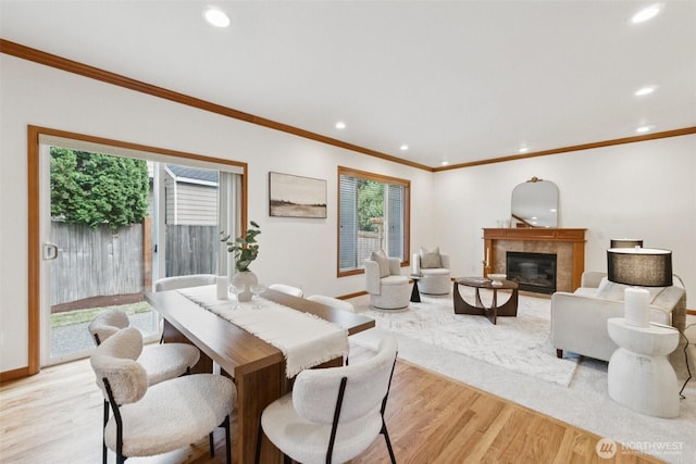 18231 2nd Pl W Unit A, Bothell, WA 98012 - dining space with light wood finished floors, crown molding, recessed lighting, and a tiled fireplace