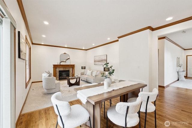 18231 2nd Pl W Unit A, Bothell, WA 98012 - dining space featuring crown molding, light wood-style floors, recessed lighting, and a glass covered fireplace