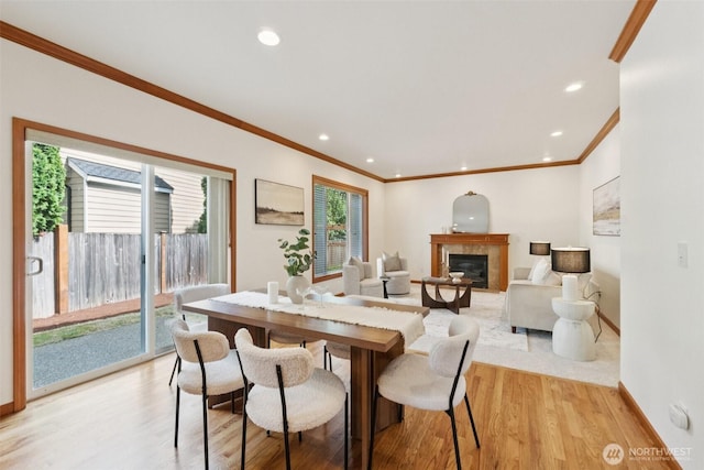 18231 2nd Pl W Unit A, Bothell, WA 98012 - dining room featuring crown molding, light wood-type flooring, a tile fireplace, and recessed lighting