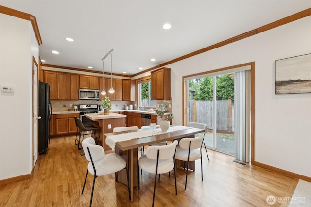 18231 2nd Pl W Unit A, Bothell, WA 98012 - kitchen with stainless steel appliances, light countertops, ornamental molding, backsplash, and light wood finished floors