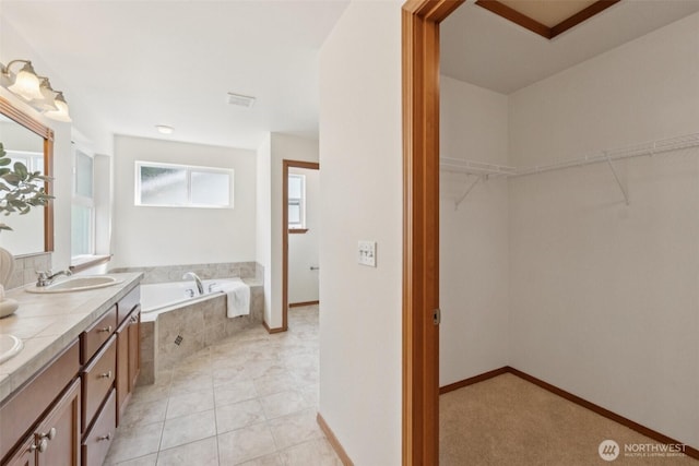 18231 2nd Pl W Unit A, Bothell, WA 98012 - full bath featuring a garden tub, double vanity, a spacious closet, and tile patterned floors
