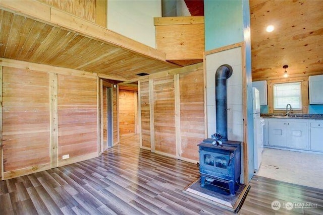 45401 Nellie Ln, Concrete, WA 98237 - unfurnished living room featuring wood ceiling, a wood stove, wood finished floors, and wood walls