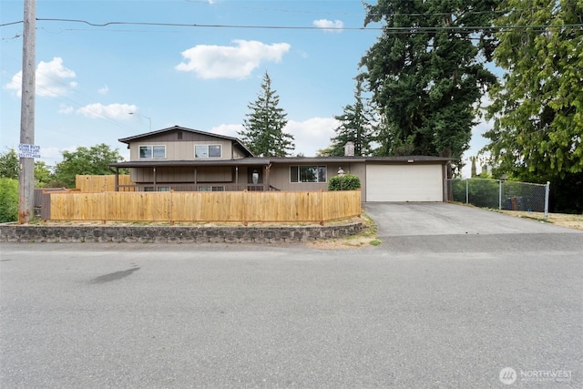 9442 S K St, Tacoma, WA 98444 - view of front of home with asphalt driveway, a garage, and a chimney
