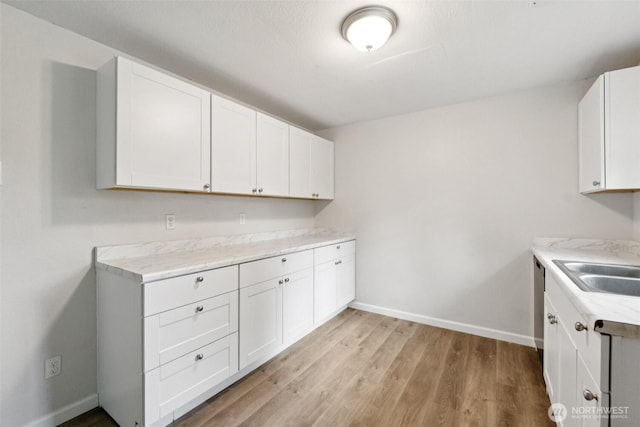 9442 S K St, Tacoma, WA 98444 - kitchen featuring light countertops, white cabinets, and light wood-style flooring