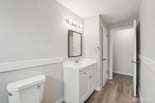 9442 S K St, Tacoma, WA 98444 - bathroom with vanity, wood finished floors, and a textured wall