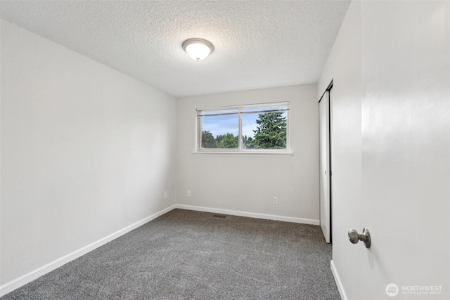 9442 S K St, Tacoma, WA 98444 - unfurnished bedroom featuring a textured ceiling, carpet flooring, and a closet