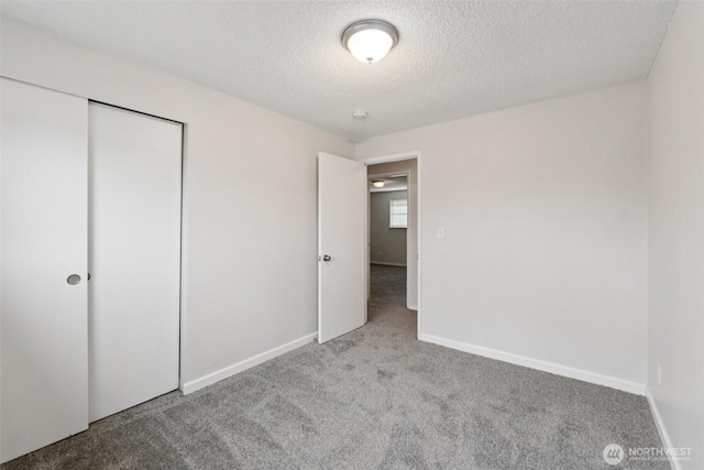 9442 S K St, Tacoma, WA 98444 - unfurnished bedroom with carpet, a textured ceiling, and a closet