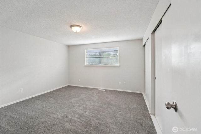 9442 S K St, Tacoma, WA 98444 - unfurnished bedroom featuring carpet flooring, a textured ceiling, and a closet