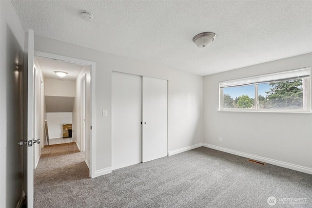 9442 S K St, Tacoma, WA 98444 - unfurnished bedroom with carpet flooring, a textured ceiling, and a closet