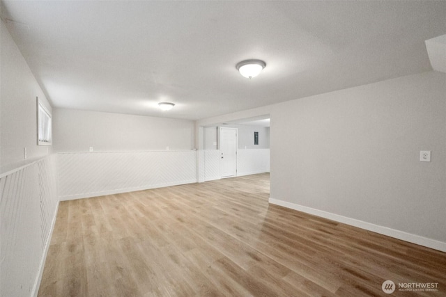 9442 S K St, Tacoma, WA 98444 - below grade area with light wood-type flooring and a wainscoted wall