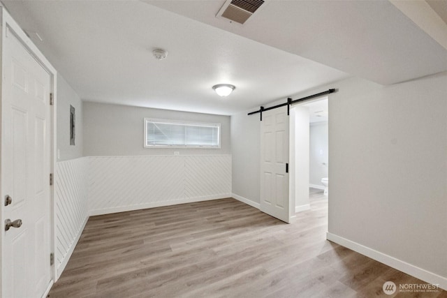 9442 S K St, Tacoma, WA 98444 - below grade area featuring a barn door and wood finished floors