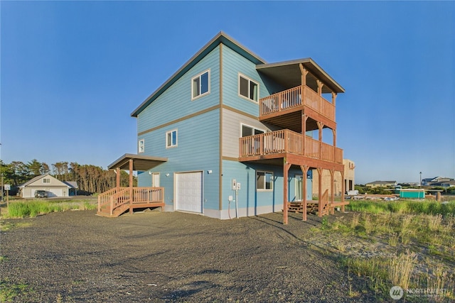 612 Dune Crest Loop, Westport, WA 98595 - back of house featuring a garage, a balcony, and a deck