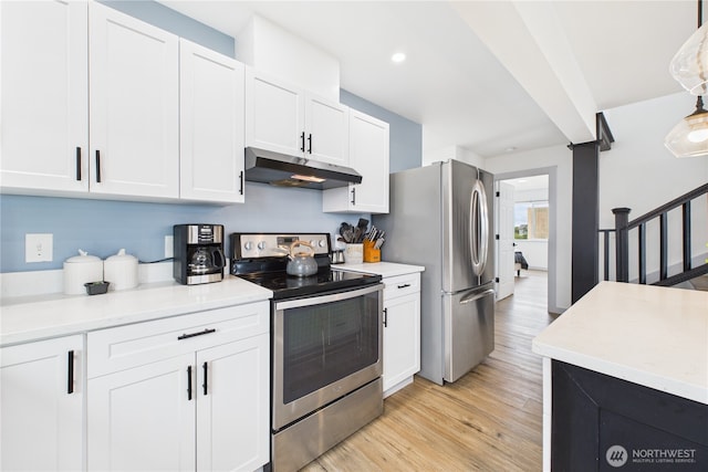 612 Dune Crest Loop, Westport, WA 98595 - kitchen with stainless steel appliances, under cabinet range hood, white cabinets, light wood finished floors, and light countertops