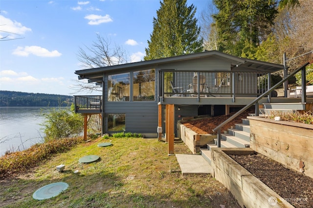 28605 Manzanita Beach Rd SW, Vashon, WA 98070 - view of front facade with a deck with water view and stairs