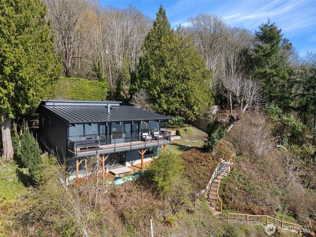 28605 Manzanita Beach Rd SW, Vashon, WA 98070 - back of house featuring a deck, a standing seam roof, a metal roof, stairway, and a view of trees