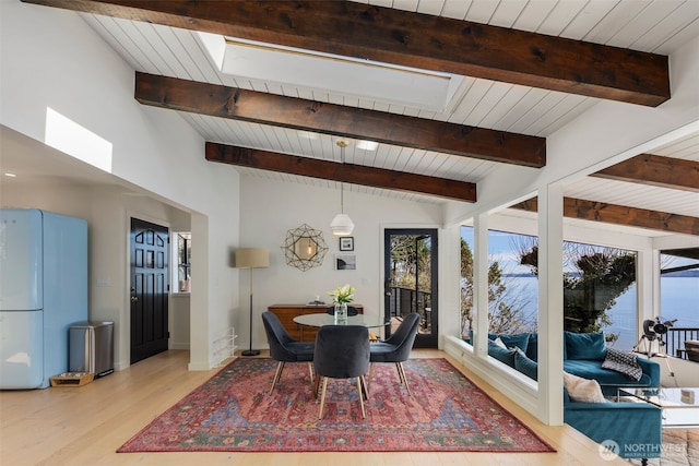 28605 Manzanita Beach Rd SW, Vashon, WA 98070 - dining space with plenty of natural light, a skylight, light wood-style floors, and wooden ceiling