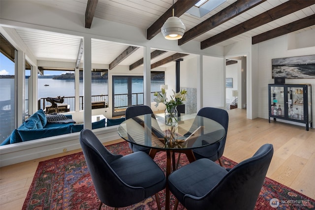 28605 Manzanita Beach Rd SW, Vashon, WA 98070 - dining room featuring hardwood / wood-style floors, a wood ceiling with exposed beams, a water view, and a skylight