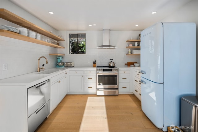 28605 Manzanita Beach Rd SW, Vashon, WA 98070 - kitchen featuring open shelves, stainless steel appliances, wall chimney range hood, light wood finished floors, and light countertops
