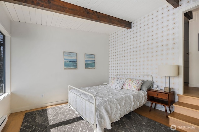 28605 Manzanita Beach Rd SW, Vashon, WA 98070 - bedroom with wood finished floors, baseboard heating, wallpapered walls, and a wood ceiling with exposed beams