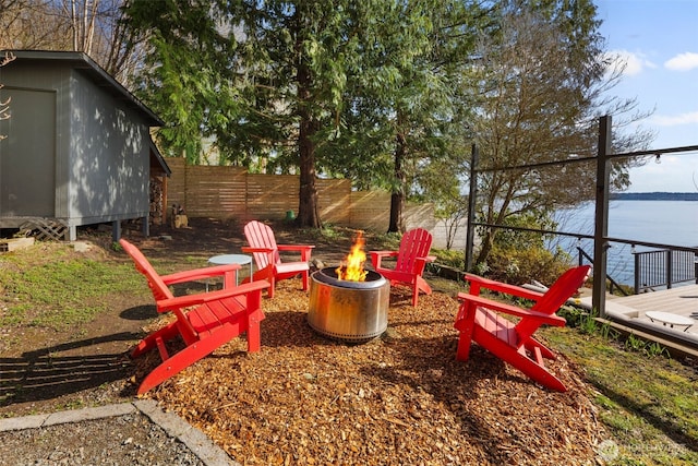 28605 Manzanita Beach Rd SW, Vashon, WA 98070 - view of yard with a fire pit, a water view, and a storage unit