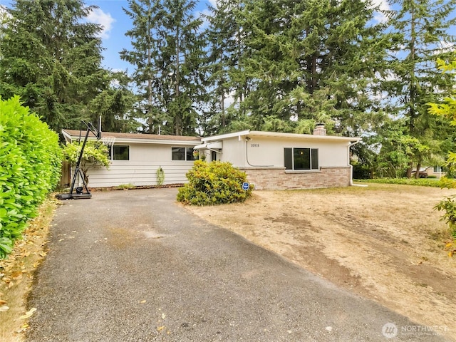 10818 108th St SW, Lakewood, WA 98498 - ranch-style home with a chimney and driveway