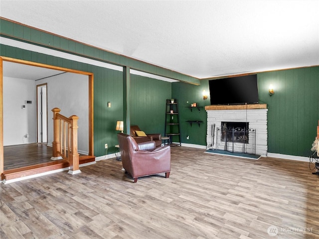 10818 108th St SW, Lakewood, WA 98498 - living room featuring wood finished floors, a brick fireplace, and wood walls