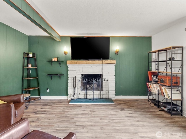 10818 108th St SW, Lakewood, WA 98498 - living room featuring wood finished floors, a fireplace, and wood walls