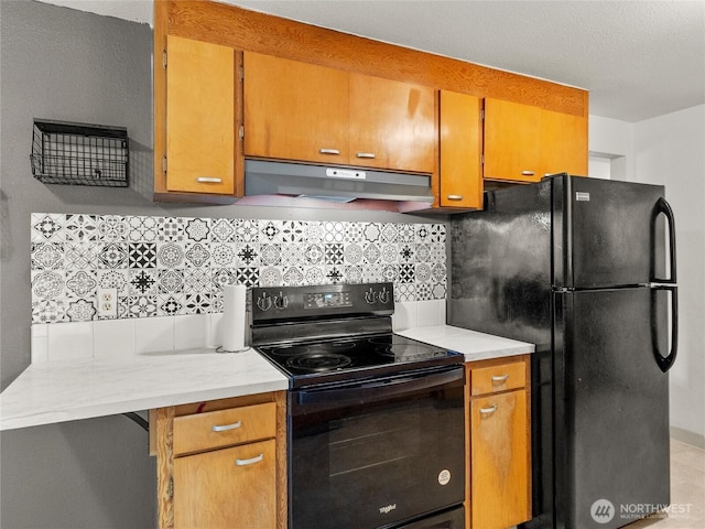 10818 108th St SW, Lakewood, WA 98498 - kitchen featuring black appliances, under cabinet range hood, light countertops, and backsplash