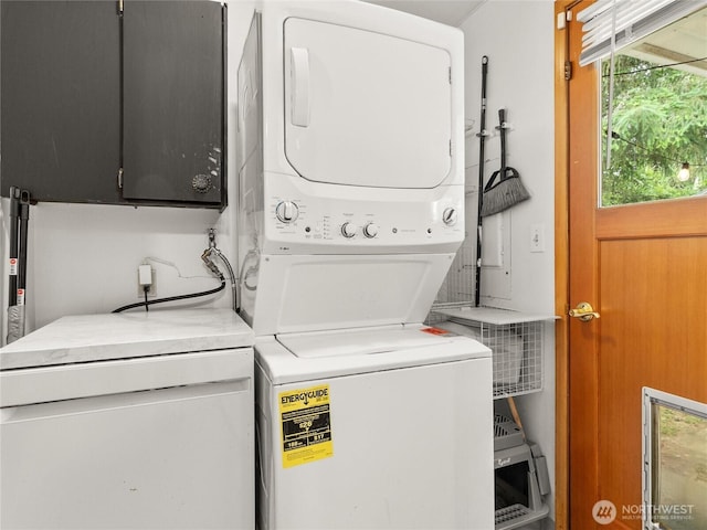 10818 108th St SW, Lakewood, WA 98498 - laundry area featuring stacked washer / drying machine and cabinet space