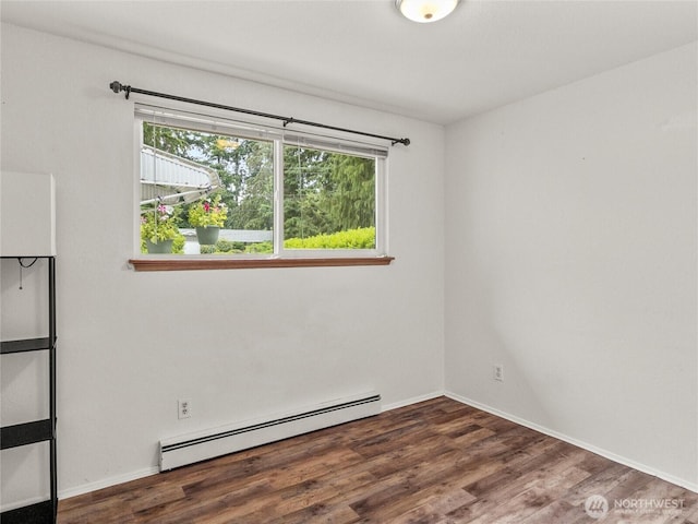 10818 108th St SW, Lakewood, WA 98498 - empty room featuring a baseboard heating unit and wood finished floors