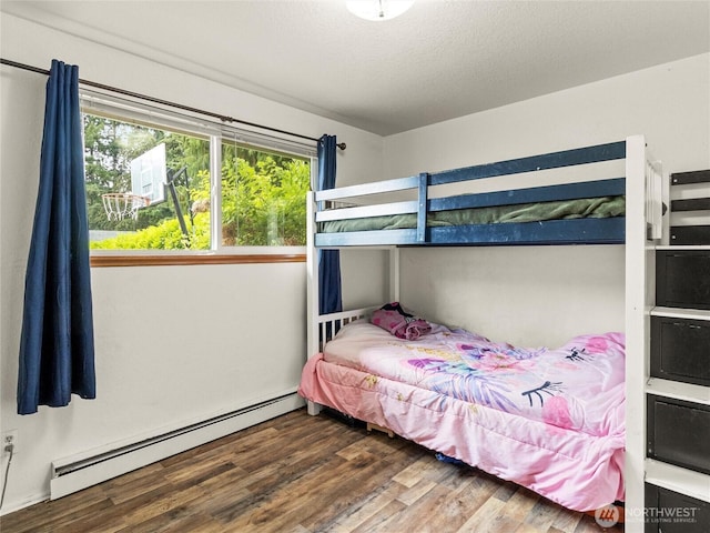 10818 108th St SW, Lakewood, WA 98498 - bedroom featuring a baseboard heating unit and wood finished floors