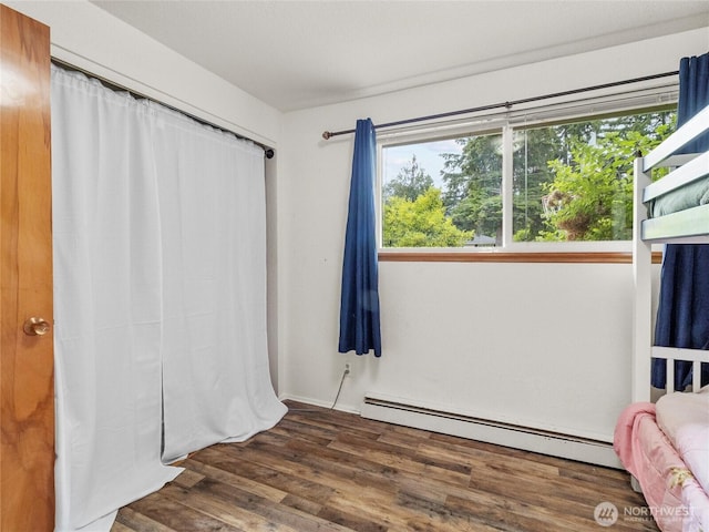 10818 108th St SW, Lakewood, WA 98498 - bedroom with baseboard heating and wood finished floors