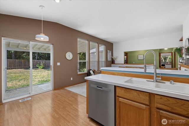 2420 Forest Ridge Dr SE, Auburn, WA 98002 - kitchen featuring stainless steel dishwasher, light countertops, pendant lighting, light wood-style flooring, and lofted ceiling