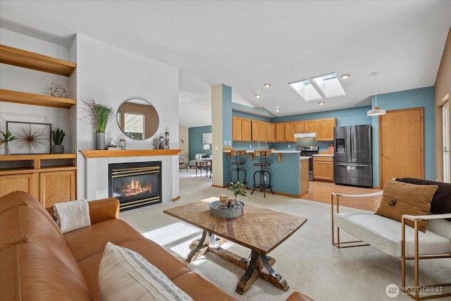 2420 Forest Ridge Dr SE, Auburn, WA 98002 - living area with a skylight, light colored carpet, vaulted ceiling, a tile fireplace, and recessed lighting