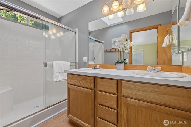 2420 Forest Ridge Dr SE, Auburn, WA 98002 - full bath featuring a shower stall, double vanity, a skylight, and wood finished floors