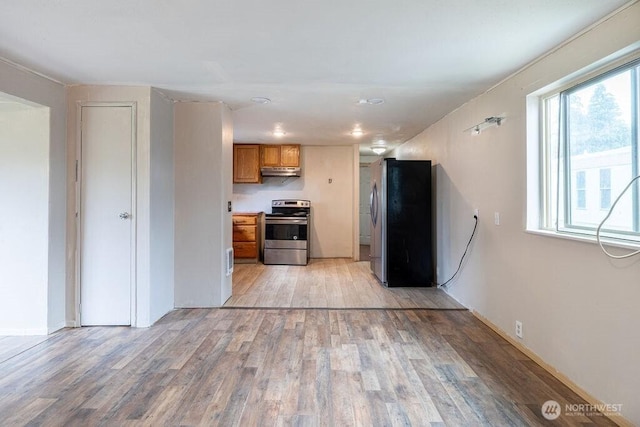 3800 Sleater Kinny Rd NE Unit 13, Olympia, WA 98506 - kitchen with stainless steel appliances, under cabinet range hood, brown cabinetry, light wood-type flooring, and healthy amount of natural light